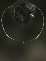 Minimalist torque with closed sculptural form