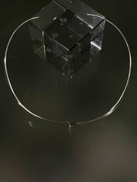 Minimalist torque with closed sculptural form