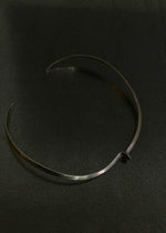 Minimalist torque with closed sculptural form