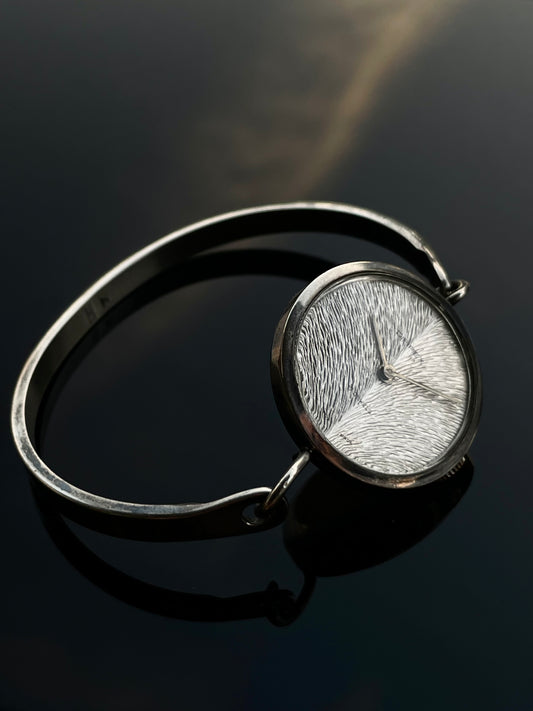 Irridescent silver bangle mechanical watch