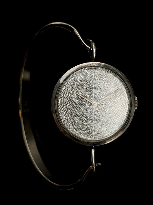 Irridescent silver bangle mechanical watch