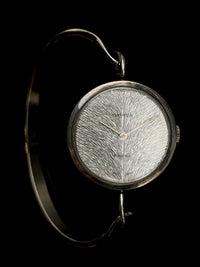 Irridescent silver bangle mechanical watch