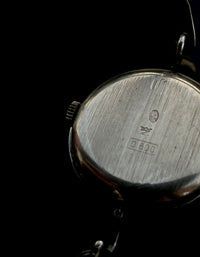 Irridescent silver bangle mechanical watch