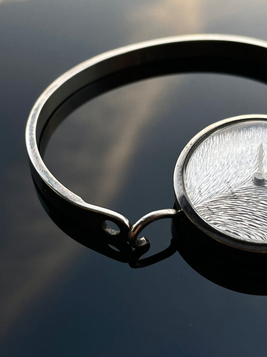 Irridescent silver bangle mechanical watch