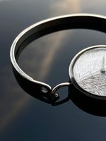 Irridescent silver bangle mechanical watch