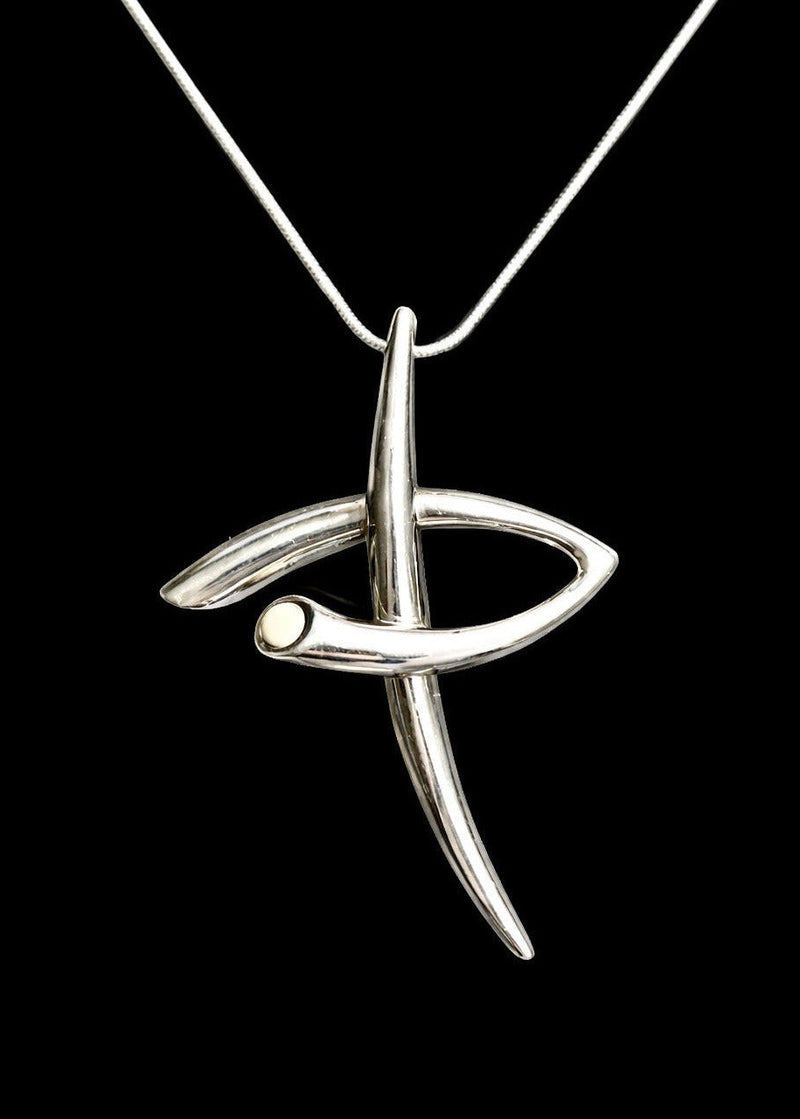 Sculptural pendant with white cabochon